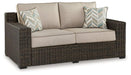 Coastline Bay Outdoor Loveseat with Cushion Outdoor Seating Ashley Furniture