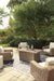 Beachcroft Beachcroft Fire Pit Table with Four Nuvella Swivel Lounge Chairs Outdoor Seating Set Ashley Furniture