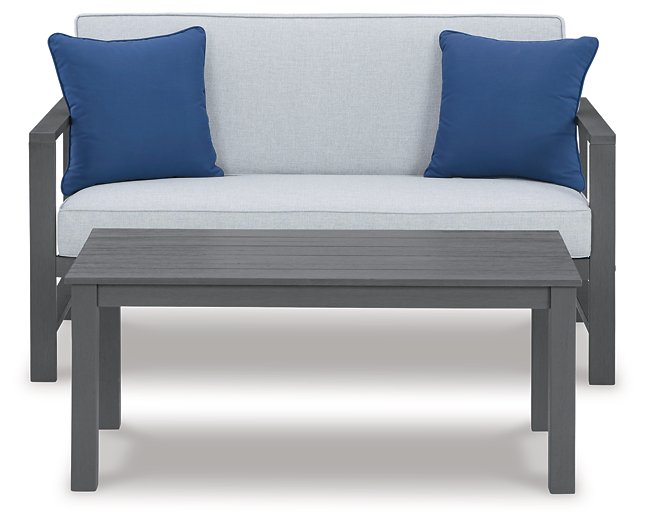 Fynnegan Outdoor Loveseat with Table (Set of 2) Outdoor Seating Set Ashley Furniture