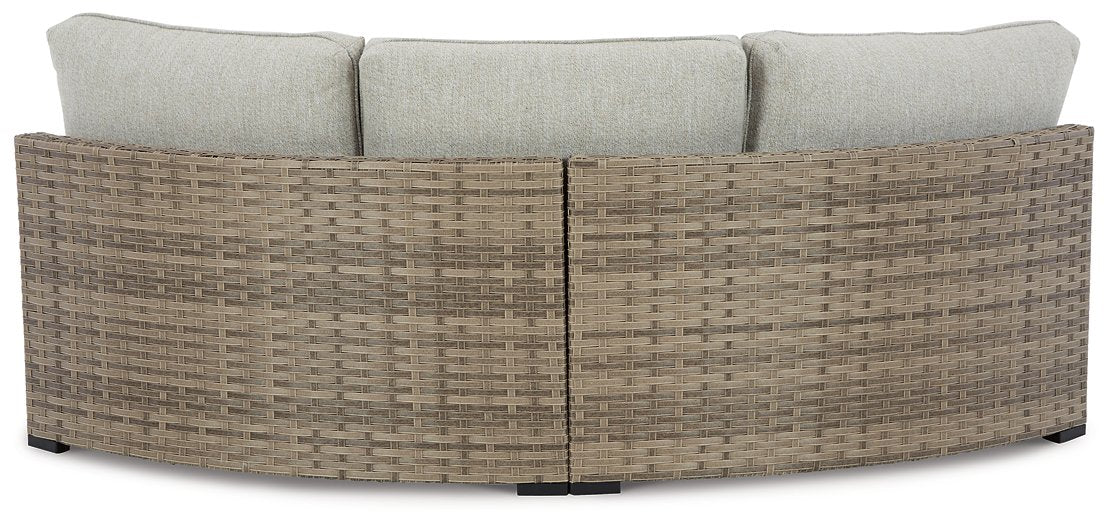 Calworth Outdoor Curved Loveseat with Cushion Outdoor Seating Ashley Furniture