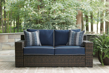 Grasson Lane Grasson Lane Nuvella Loveseat with Fire Pit Table Outdoor Table Set Ashley Furniture